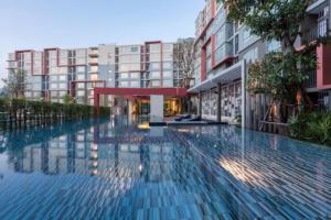 a large swimming pool in front of a building at Dcondo Kathu Patong Phuket by Suna in Kathu