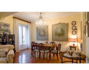 a dining room with a table and chairs and a chandelier at La Luna sul Porto in Santa Margherita Ligure
