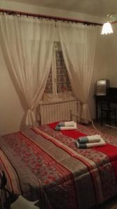 ラ・スペツィアにあるB&B Mare e Montiのベッドルーム1室(赤いシーツ付きのベッド1台、窓付)