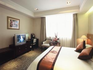 a hotel room with a bed and a television at Donghu Guest House in Shanghai