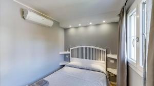 a small bedroom with a bed and a window at B&B Bessy 10 in Antibes