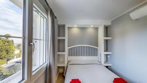 a small bedroom with a bed next to a window at B&B Bessy 10 in Antibes