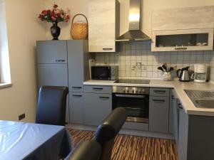a kitchen with a sink and a stove top oven at Ferienwohnung Mujcic in Hermagor