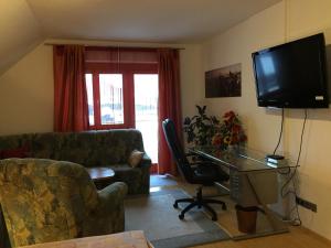 a living room with a couch and a television at Ferienwohnung Mujcic in Hermagor