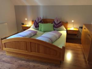 a large wooden bed with two pillows on it at Ferienwohnung Mujcic in Hermagor