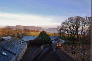 an aerial view of roofs of houses with mountains in the background at Ardtarmon Garden Cottage in Sligo