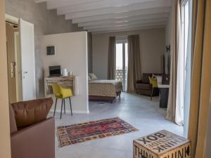a living room with yellow chairs and a couch at Hotel Buena Onda in Peschiera del Garda