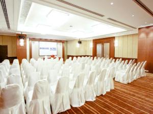 einen Konferenzraum mit weißen Stühlen und einem Bildschirm in der Unterkunft Intimate Hotel Pattaya - SHA Extra Plus in Pattaya + 37 Fotos