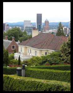 a white house with a view of a city at Portland International Guesthouse in Portland