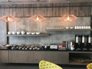 a kitchen with a counter with several lights above it at The Preston House and Hotel in Riverhead