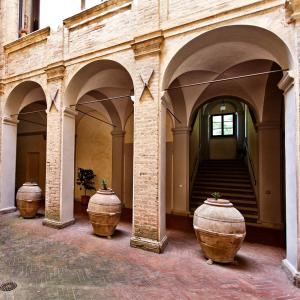 three large vases sitting in the middle of a building at Villa Osperellone in Perugia