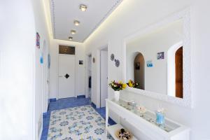a bathroom with a sink and a mirror at Chez Amélie in Amalfi