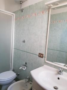 a bathroom with a white toilet and a sink at B&B Rudy in Rome