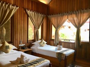 Postel nebo postele na pokoji v ubytování Inle Cottage Boutique Hotel