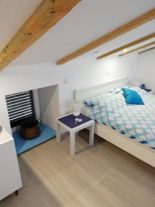 a bedroom with a bed and a table at Apartment Vrbenka in Vrbnik