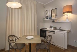 a kitchen with a table and a sink and a stove at the river in Pisa