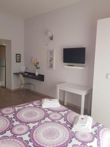 a bedroom with a bed with a table and a tv at B&B La Veduta in Naples