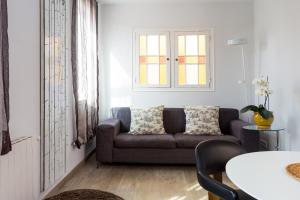 - un salon avec un canapé et une table dans l'établissement Quartprimera Apartments, à Barcelone