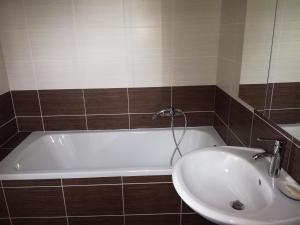 a bathroom with a white tub and a sink at Comfortable house for relax and sports in Hněvkovice