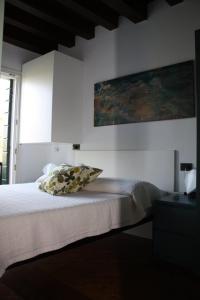 a bedroom with a bed with a painting on the wall at Ca' Torcello in Venice