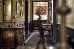 a person walking through a hallway in a room with a table at Castel Bois Marie, Maison d'hôtes in Montauban