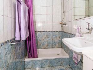 a bathroom with a sink and a bath tub and a sink at Detached Holiday house few steps from the beach in Veli Rat