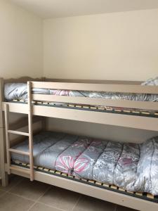 a bunk bed room with two bunk beds at Les maisonnettes de bonneval in Jaujac