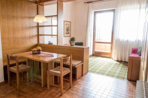 eine Küche mit einem Tisch und Stühlen sowie einem Fenster in der Unterkunft Residence Des Alpes in Asiago