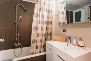 a bathroom with a shower and a sink and a tub at Best Private Rooms in apartment in safe area in Athens