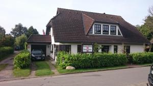 a house with a car parked in the driveway at Ferienwohnung "Seeblick" in Zingst