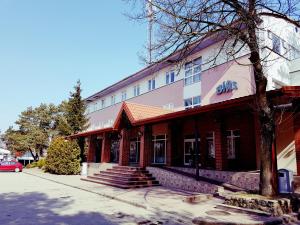a building with a sign on the side of it at Zajazd Bias in Wyszków