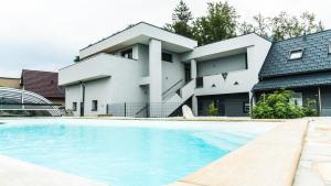 a house with a swimming pool in front of it at Kogelschneiderhof in Dobl-Zwaring