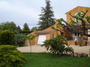 une maison avec garage dans une cour dans l'établissement Le Nid au Pied du Mont Ventoux, à Malaucène