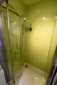 a shower stall with a glass door in a bathroom at No. 1 Caberfeidh in Fort William