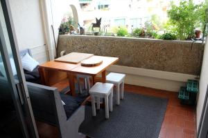 a balcony with a table and chairs and a window at Studio 237 Port Camargue, Piscine, Climatisation, 2 personnes in Le Grau-du-Roi