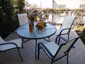 un tavolo blu con sedie e un vaso di fiori di Apartment Napitia Hills a Pizzo