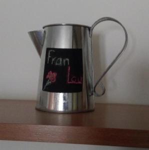 a metal tea pot sitting on a wooden shelf at franlau in Mora de Rubielos