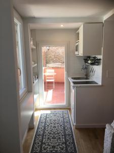 a kitchen with a door leading to a patio at Montoro 15 Attic Suite in Rome