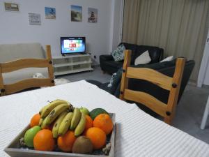 a tray of fruit on a table in a living room at Adonis Apartment in Paphos