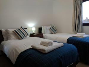 a hotel room with two beds and a window at Kings Lodge in Telford