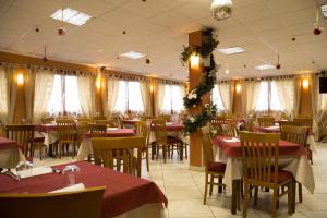 a dining room with tables and chairs and curtains at La Magione in Serravalle Pistoiese +24 photos