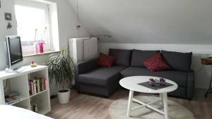 a living room with a couch and a table at Haus Nautilus in Helgoland