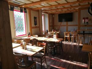 a dining room with tables and chairs and a television at Hotel Bilger Eck in Konstanz