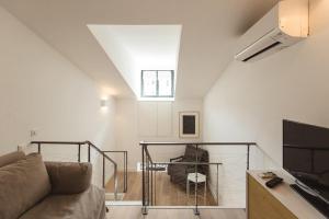 a living room with a couch and a tv at Residence Tonduti in Nice