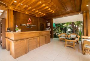 a restaurant with a bar with chairs and a table at Lanta Nice Beach Resort - SHA Extra Plus in Ko Lanta +110 photos