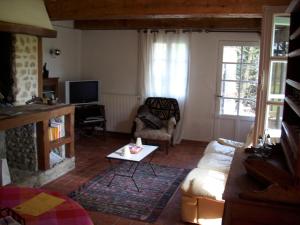 a living room with a couch and a fireplace at La Palestriere in Cuy-Saint-Fiacre
