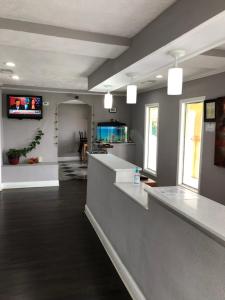 a kitchen with white counter tops in a room at Scottish Inns Manchester in Manchester