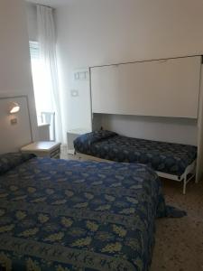 A bed or beds in a room at Hotel Imperiale