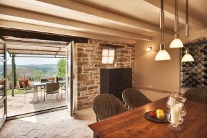 a dining room with a table and chairs and a fireplace at Casa Meloni in Motovun