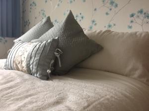 a pile of pillows sitting on top of a bed at Grey Gables Farmhouse B&B in Inishannon